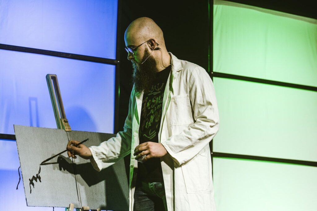 A man in a lab coat holding a piece of paper