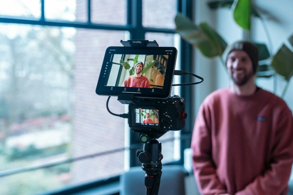 Man filming himself with camera and monitor